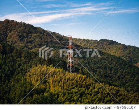 Autumn mountains and high-voltage line towers Autumn mountains and high-voltage line towers 87586107