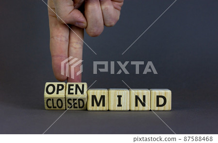 Open or closed mind symbol. Businessman turns cubes and changes concept words closrd mind to open mind. Beautiful grey table, grey background, copy space. Business open or closed mind concept. 87588468