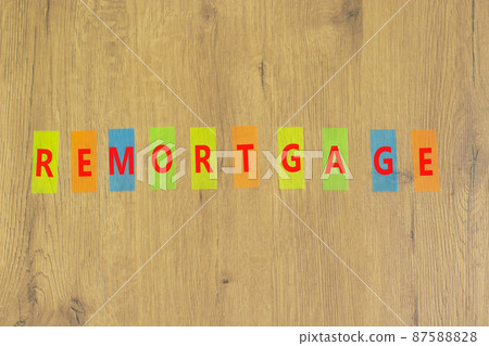 Remortgage success symbol. The concept word Remortgage on colored papers on a beautiful wooden background. Business and remortgage success concept, copy space. 87588828