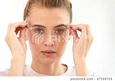 Close-up shot of smiling attractive happy and successful european blond female in sweater watch and glasses grinning expressing confidence, looking accomlished and daring at camera with sassy smile. Close-up shot of smiling attractive happy and successful european blond female in sweater watch and glasses grinning expressing confidence, looking accomlished and daring at camera with sassy smile. 87589728