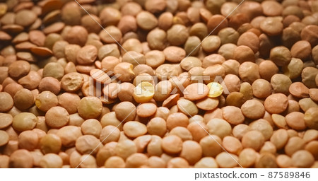 Closeup photo of natural dried brown lentils rotating Closeup photo of natural dried brown lentils rotating 87589846