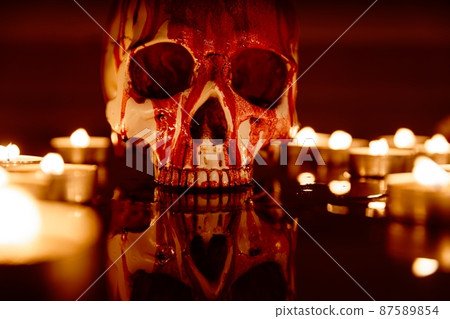 Blood stained skull against dark background closeup 87589854