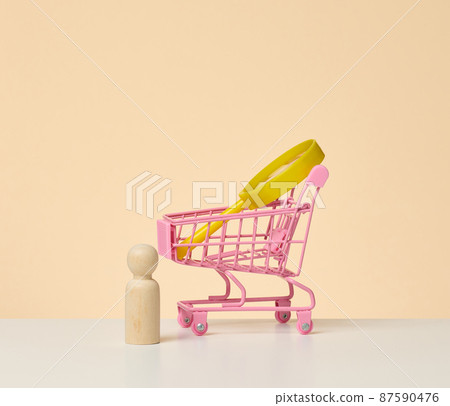 figurines of men on a white table and magnifying glass. Concept of searching for employees in the company, recruiting personnel, identifying talented and strong personaliti 87590476