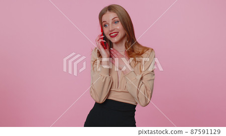 Businesswoman girl having pleasant mobile phone conversation using smartphone telling good news Businesswoman girl having pleasant mobile phone conversation using smartphone telling good news 87591129