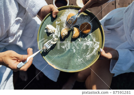 Couple having breakfast in luxury resort. Sunny day Couple having breakfast in luxury resort. Sunny day 87591281