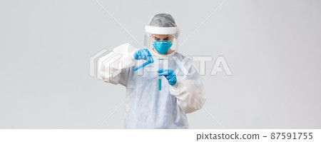 Covid-19, medical research, healthcare workers and quarantine concept. Tech lab doctor in clinic working on coronavirus vaccine, pouring liquid in another test-tube, wear personal protective costume Covid-19, medical research, healthcare workers and quarantine concept. Tech lab doctor in clinic working on coronavirus vaccine, pouring liquid in another test-tube, wear personal protective costume 87591755