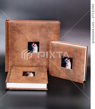 wedding photobooks in brown leather binding with photos on the cover 87591985