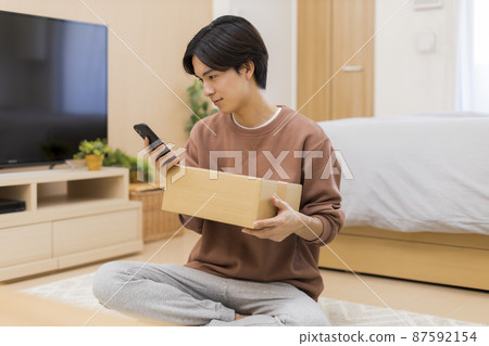 Cardboard smartphone young man Cardboard smartphone young man 87592154