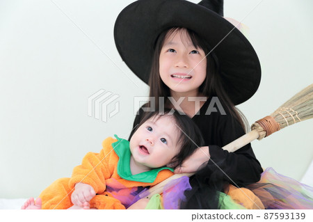 Infant girls and sisters dressed up for Halloween Infant girls and sisters dressed up for Halloween 87593139