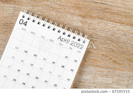 April 2022 desk calendar on wooden background. April 2022 desk calendar on wooden background. 87595555