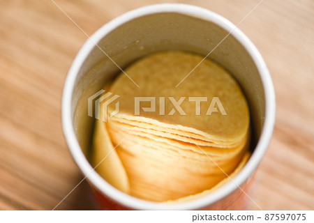 Potato hips on cans paper, Stacked potato chips is snack in package ready to eat and fat food or junk food 87597075