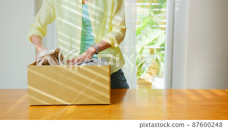 woman is recycling at home 87600248