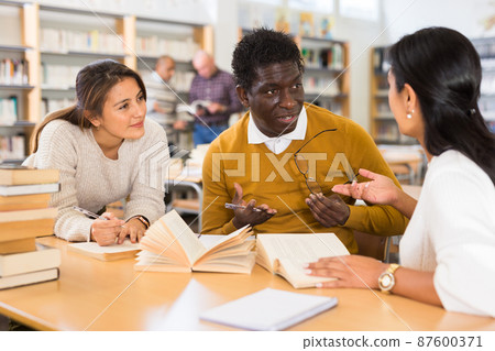 Group of adult people studying in library Group of adult people studying in library 87600371