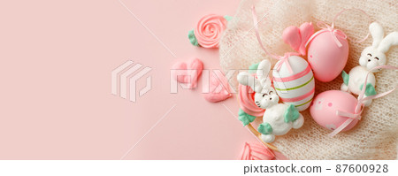 Colorful easter painted eggs, sweet funny merengue on pink pastel color background, space. Easter holiday concept. Traditional decoration, springtime holiday. Top view easter greeting card, banner 87600928