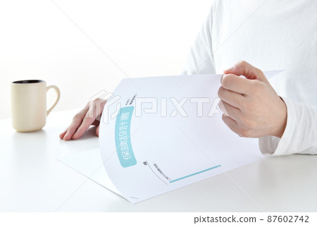 A woman's hand to check the insurance design document A woman's hand to check the insurance design document 87602742