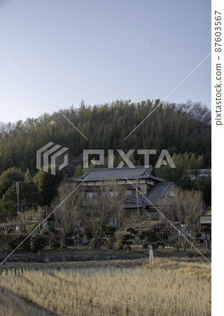 Winter countryside with an old folk house Winter countryside with an old folk house 87603567