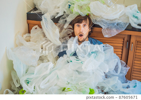 The man used too many plastic bags that they filled up the entire kitchen. Zero waste concept. The concept of World Environment Day The man used too many plastic bags that they filled up the entire kitchen. Zero waste concept. The concept of World Environment Day 87605671