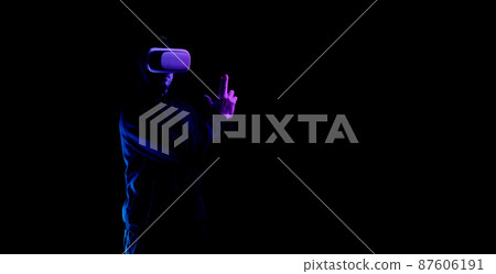 Vr goggles virtual reality. Young man in digital helmet for 3d virtual reality game isolated on black neon background. Study and virtual world in 3D simulation. Vr goggles virtual reality. Young man in digital helmet for 3d virtual reality game isolated on black neon background. Study and virtual world in 3D simulation. 87606191