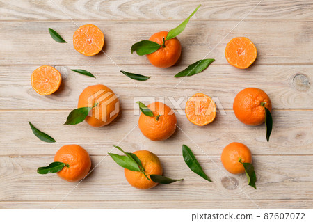 Many fresh ripe mandarin as colored background, top view. Elegant background of clementines and mandarin slices Top view flat lay Many fresh ripe mandarin as colored background, top view. Elegant background of clementines and mandarin slices Top view flat lay 87607072