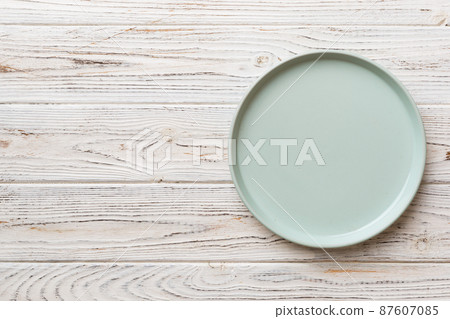 Top view of empty blue plate on wooden background. Empty space for your design 87607085