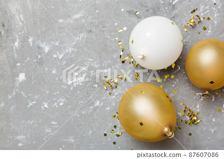Background with fastive air balloons of round shape and confetti, multicoloured top view. Birthday party background 87607086