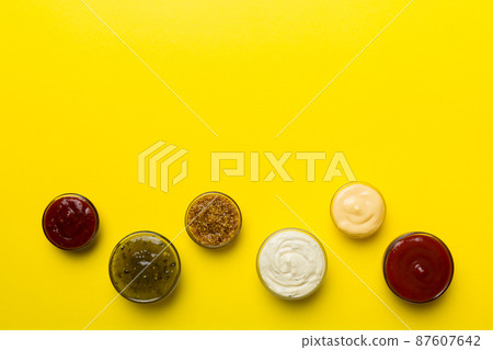 Different types of sauces in bowls on a colored Board . Top view. various sauces copy space 87607642