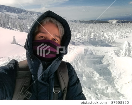 Young Man Smile Camera Taking Selfie Photo on top viewpoint mountain Zao, Yamagata. with snow monster background. 87608530