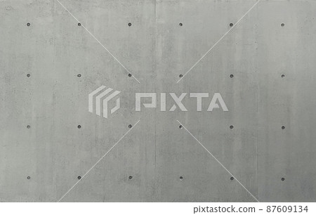 帶分離孔的深灰色混凝土牆表面的背景圖像 87609134