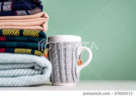 Stack of woolen checked blankets Stack of woolen checked blankets 87609515