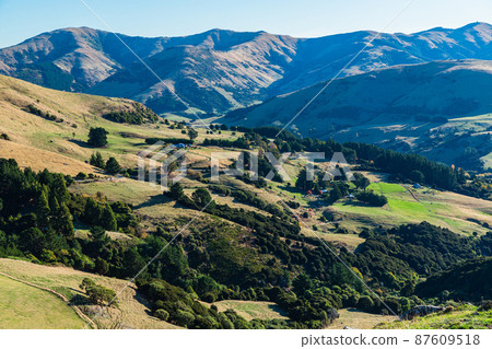 A view of the Banks Peninsula from a hill on the outskirts of Akaroa, a town on the South Island of New Zealand A view of the Banks Peninsula from a hill on the outskirts of Akaroa, a town on the South Island of New Zealand 87609518