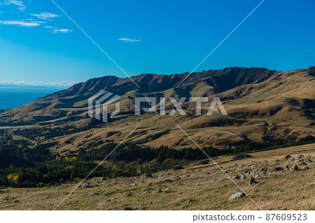 A view of the Banks Peninsula from a hill on the outskirts of Akaroa, a town on the South Island of New Zealand A view of the Banks Peninsula from a hill on the outskirts of Akaroa, a town on the South Island of New Zealand 87609523
