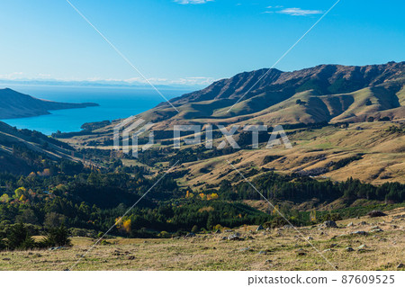 A view of the Banks Peninsula from a hill on the outskirts of Akaroa, a town on the South Island of New Zealand 87609525