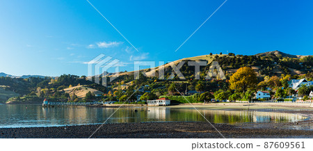 A town located on the Banks Peninsula on the South Island of New Zealand, the streets of Akaroa and the scenery of Akaroa Bay A town located on the Banks Peninsula on the South Island of New Zealand, the streets of Akaroa and the scenery of Akaroa Bay 87609561