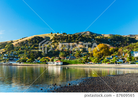 A town located on the Banks Peninsula on the South Island of New Zealand, the streets of Akaroa and the scenery of Akaroa Bay A town located on the Banks Peninsula on the South Island of New Zealand, the streets of Akaroa and the scenery of Akaroa Bay 87609565