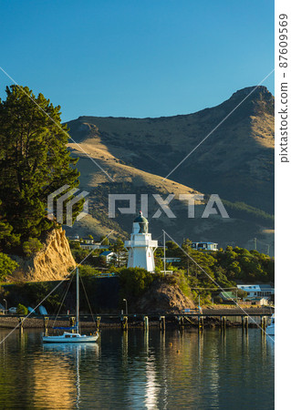 Scenery of Akaroa Lighthouse and Akaroa Bay, a town located on the Banks Peninsula on the South Island of New Zealand Scenery of Akaroa Lighthouse and Akaroa Bay, a town located on the Banks Peninsula on the South Island of New Zealand 87609569
