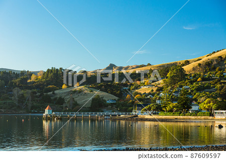 A town located on the Banks Peninsula on the South Island of New Zealand, the streets of Akaroa and the scenery of Akaroa Bay A town located on the Banks Peninsula on the South Island of New Zealand, the streets of Akaroa and the scenery of Akaroa Bay 87609597