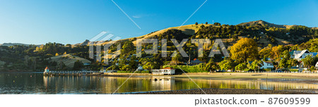A town located on the Banks Peninsula on the South Island of New Zealand, the streets of Akaroa and the scenery of Akaroa Bay A town located on the Banks Peninsula on the South Island of New Zealand, the streets of Akaroa and the scenery of Akaroa Bay 87609599