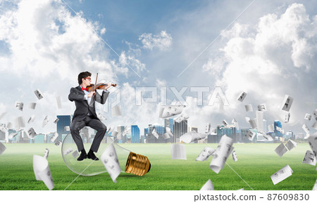 Young businessman plays the violin 87609830