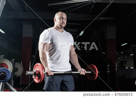 Male athlete lifts the barbell Male athlete lifts the barbell 87609853