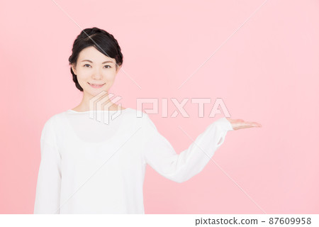 A woman in a white blouse guided by hand A woman in a white blouse guided by hand 87609958
