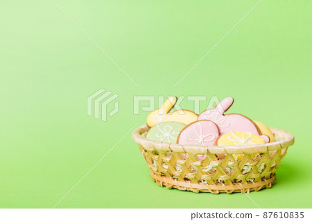 Colorful easter cookies in basket with Multi colors Easter eggs on colored background . Pastel color Easter eggs. holiday concept with copy space 87610835