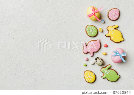 holiday preparation Multi colors Easter eggs with cookies on colored background . Pastel color Easter eggs. holiday concept with copy space holiday preparation Multi colors Easter eggs with cookies on colored background . Pastel color Easter eggs. holiday concept with copy space 87610844