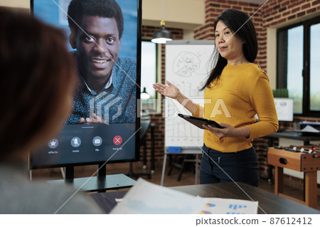 Businesswoman explaining marketing strategy with remote manager 87612412