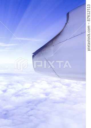 A wonderful view from the window of an airplane, a dark blue sky, light A wonderful view from the window of an airplane, a dark blue sky, light 87612513