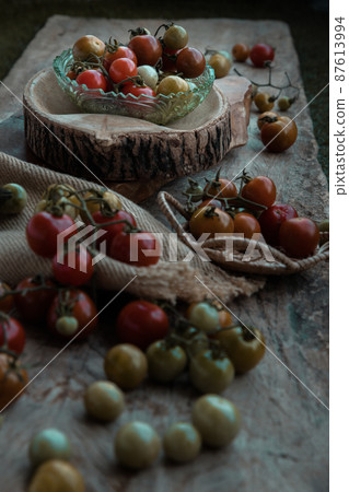 Group of Colorful variety of Fresh wild tomatoes (Mini Cherry Tomatos) on old wooden board background. 87613994