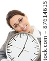Young woman holding a clock. 87614615