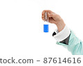 Holding test tube with blue liquid. 87614616