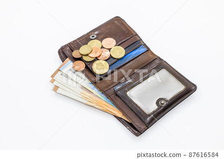 Open brown leather wallet with money and credit cards 87616584