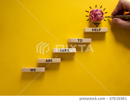 Business concept growth success process. Wood blocks stacking as step stair on yellow background, copy space. Businessman hand. Words 'we are here to help'. Conceptual image of motivation. Business concept growth success process. Wood blocks stacking as step stair on yellow background, copy space. Businessman hand. Words 'we are here to help'. Conceptual image of motivation. 87616961