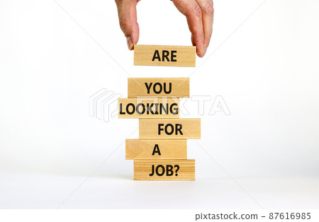 Symbol of building success foundation. Businessman put wooden blocks on the stack of wooden blocks. Words Are you looking for a job. Beautiful white background, copy space. Business, job concept. Symbol of building success foundation. Businessman put wooden blocks on the stack of wooden blocks. Words Are you looking for a job. Beautiful white background, copy space. Business, job concept. 87616985